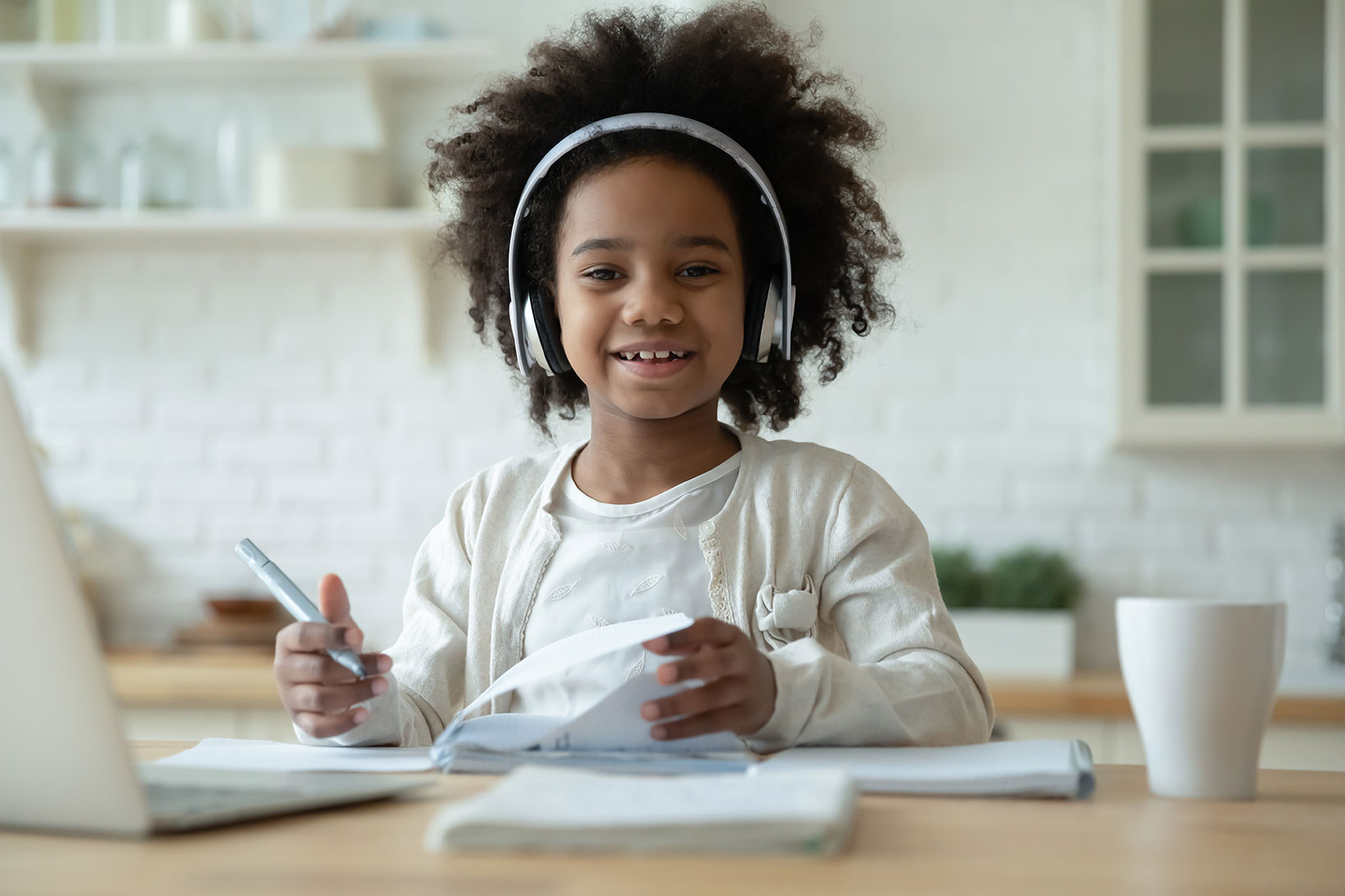 A Child Enjoying Music While Studying